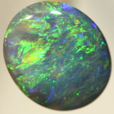 SOLID BLACK OPAL Bright orange and green over a blue background. SEE VIDEO